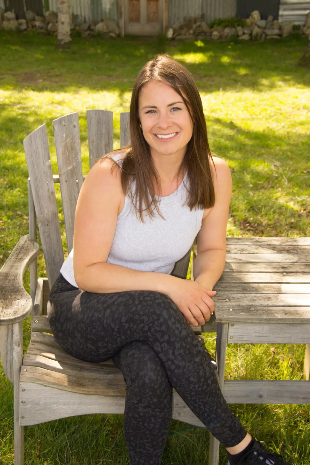 Trainer sitting outside on wooden chair