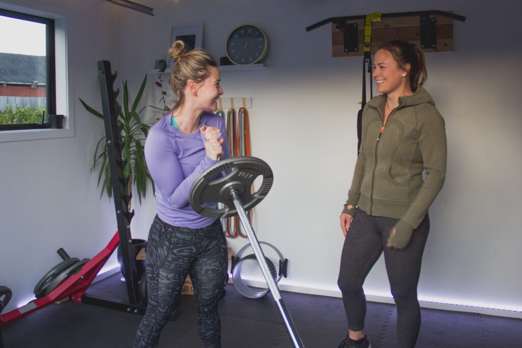 Personal training session with trainer and client enjoying a moment together