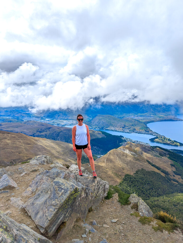 Carolyn on a hike at the top of Ben Lomond looking at Queenstown