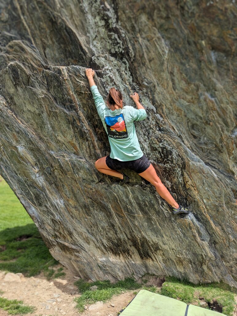 Carolyn climbing on a boulder in the Jardines