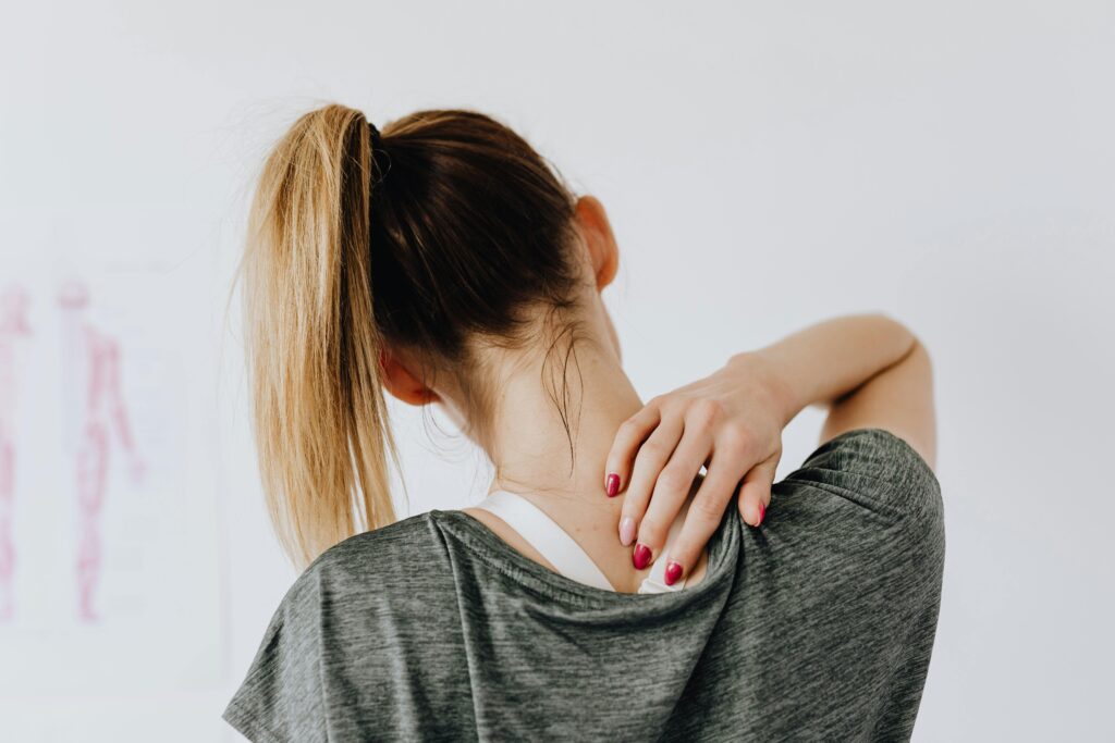Woman holding shoulder because she's in pain