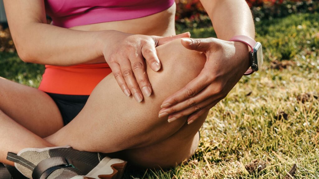 woman holding her knee in pain